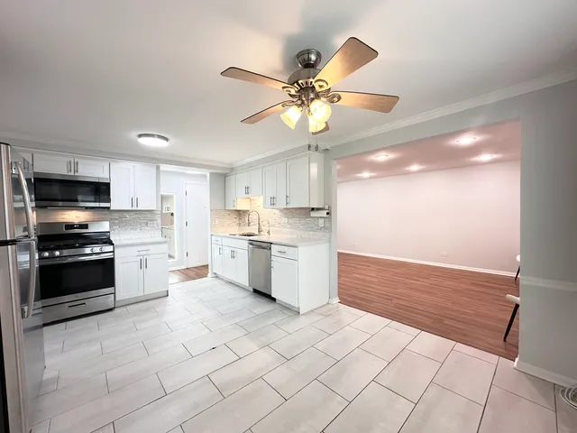 a kitchen with a stove a sink and a refrigerator