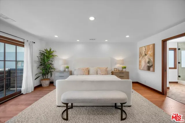 a living room with furniture a potted plant and a table
