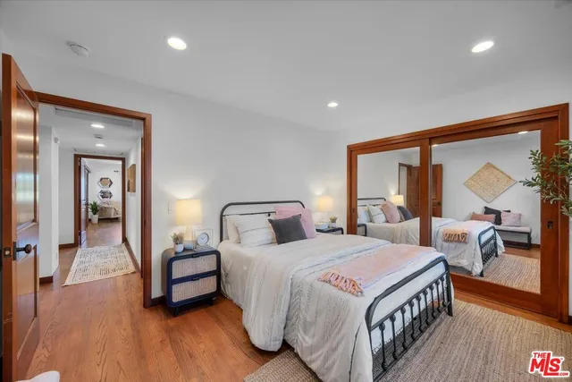 a bedroom with two beds and a large window