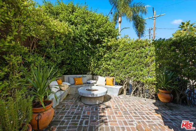 a view of a balcony with chairs and a potted plant