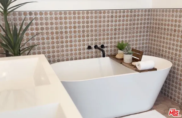 a white bath tub sitting in a bathroom