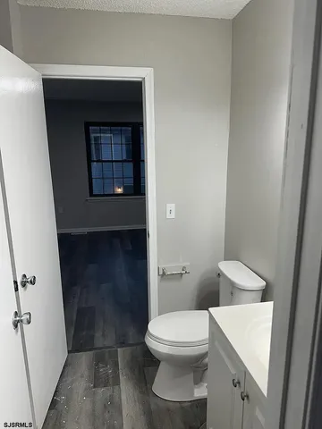 a white toilet sitting next to a white sink