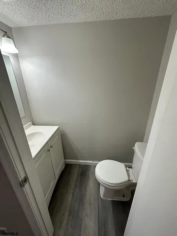 a white toilet sitting next to a white sink