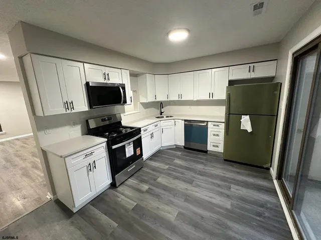 a kitchen with a refrigerator a sink and a stove
