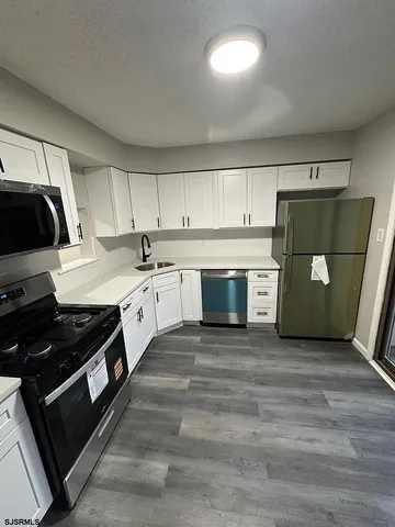 a kitchen with a sink and a stove top oven