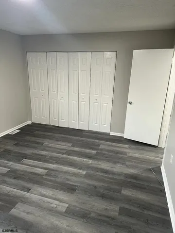 a view of wooden floor and closet