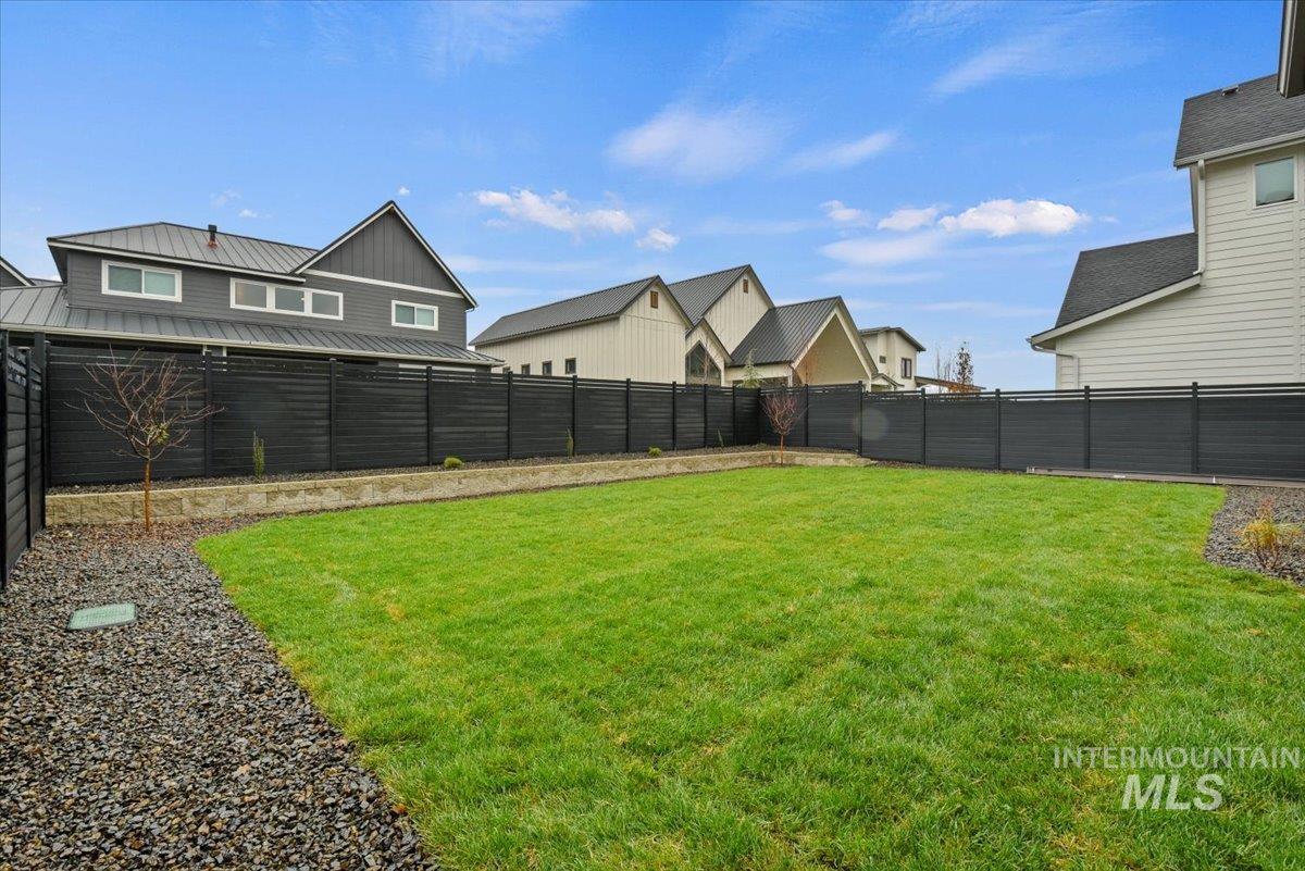 7660 West Old School Street, Unit ROUGE Meridian, ID 83646 - Photo 17 of 28 Fenced backyard featuring a residential view