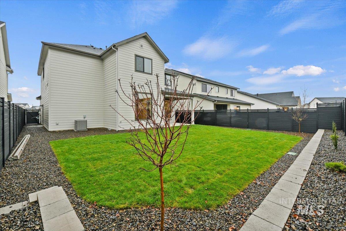 7660 West Old School Street, Unit ROUGE Meridian, ID 83646 - Photo 18 of 28 Back of house featuring a fenced backyard