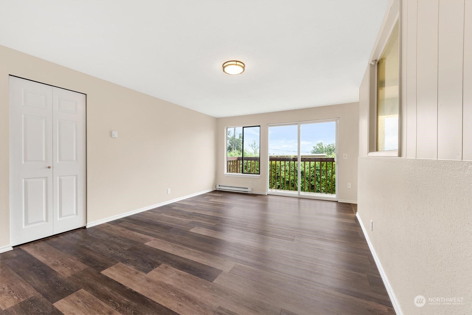 1715 16th Avenue South Seattle, WA 98144 - Photo 14 of 38 a view of an empty room with wooden floor and a window