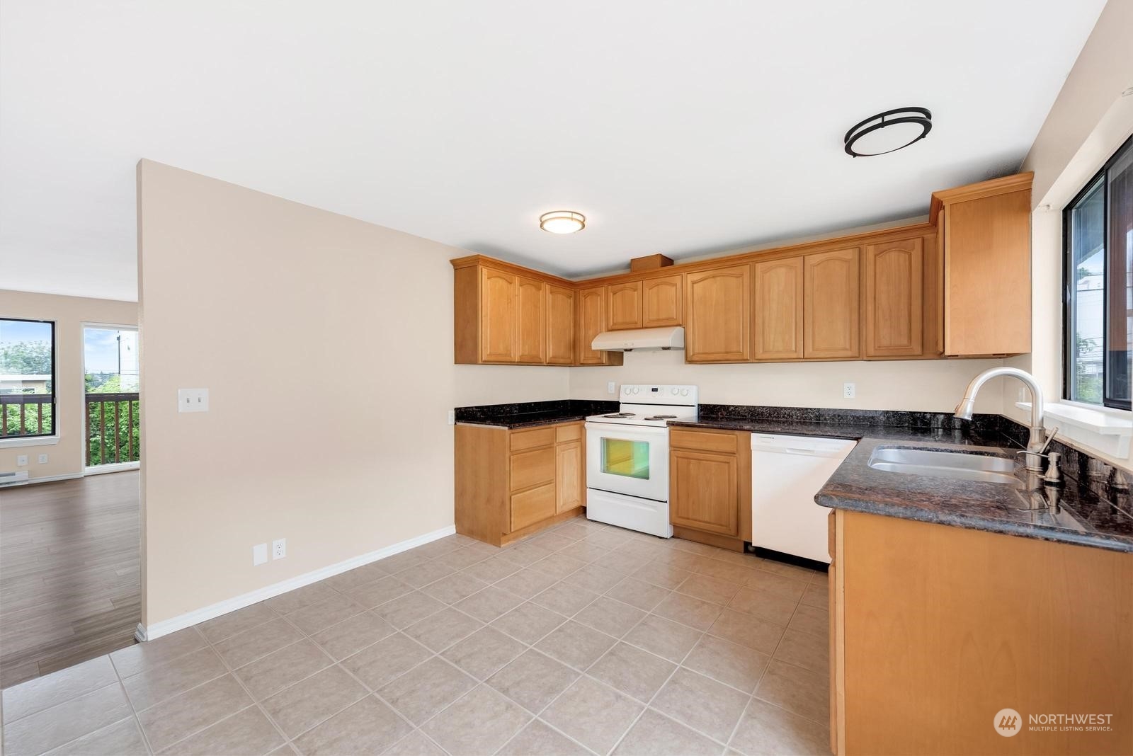 1715 16th Avenue South Seattle, WA 98144 - Photo 20 of 38 a kitchen with granite countertop a sink a stove cabinets and counter space
