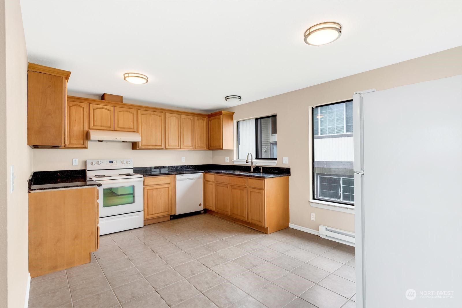 1715 16th Avenue South Seattle, WA 98144 - Photo 22 of 38 a kitchen with stainless steel appliances granite countertop a stove a sink and a refrigerator