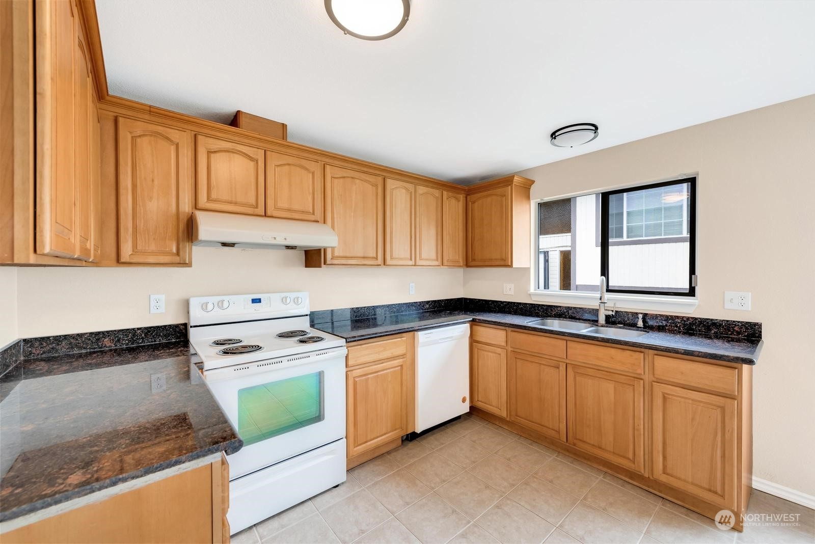 1715 16th Avenue South Seattle, WA 98144 - Photo 23 of 38 a kitchen with stainless steel appliances granite countertop a stove sink and cabinets