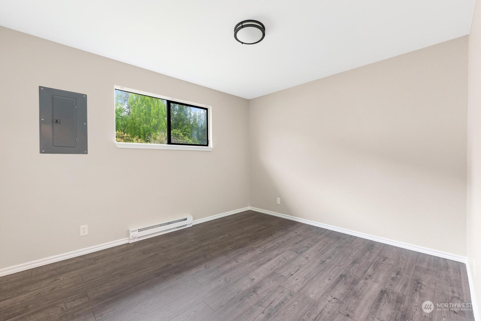 1715 16th Avenue South Seattle, WA 98144 - Photo 25 of 38 an empty room with wooden floor and windows