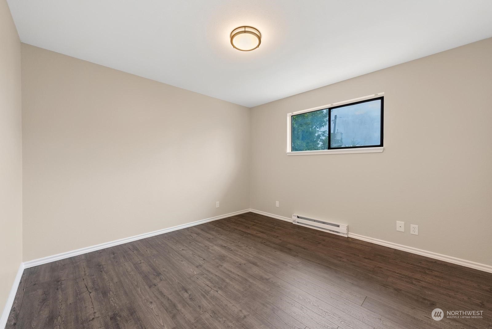 1715 16th Avenue South Seattle, WA 98144 - Photo 28 of 38 an empty room with wooden floor and window