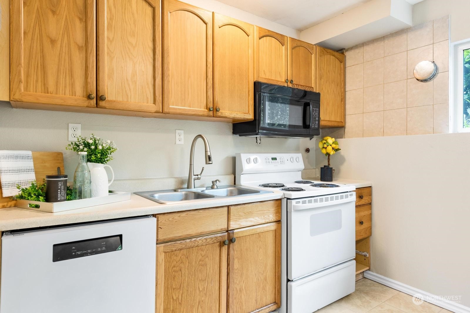 1715 16th Avenue South Seattle, WA 98144 - Photo 7 of 38 a kitchen with stainless steel appliances granite countertop a sink a stove a microwave a sink and cabinets