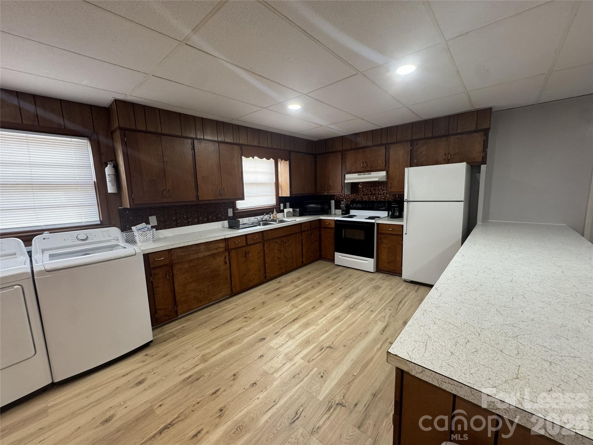 319 Connelly Springs Road, Unit A Lenoir, NC 28645 - Photo 4 of 10 a kitchen with sink a microwave and refrigerator
