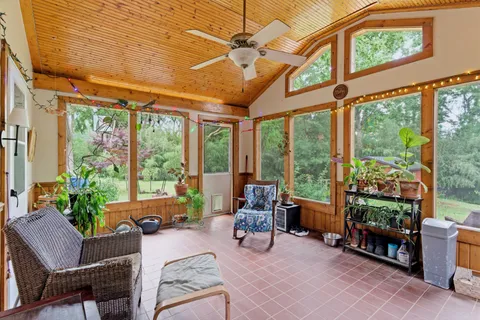 a living room filled with furniture and a potted plant