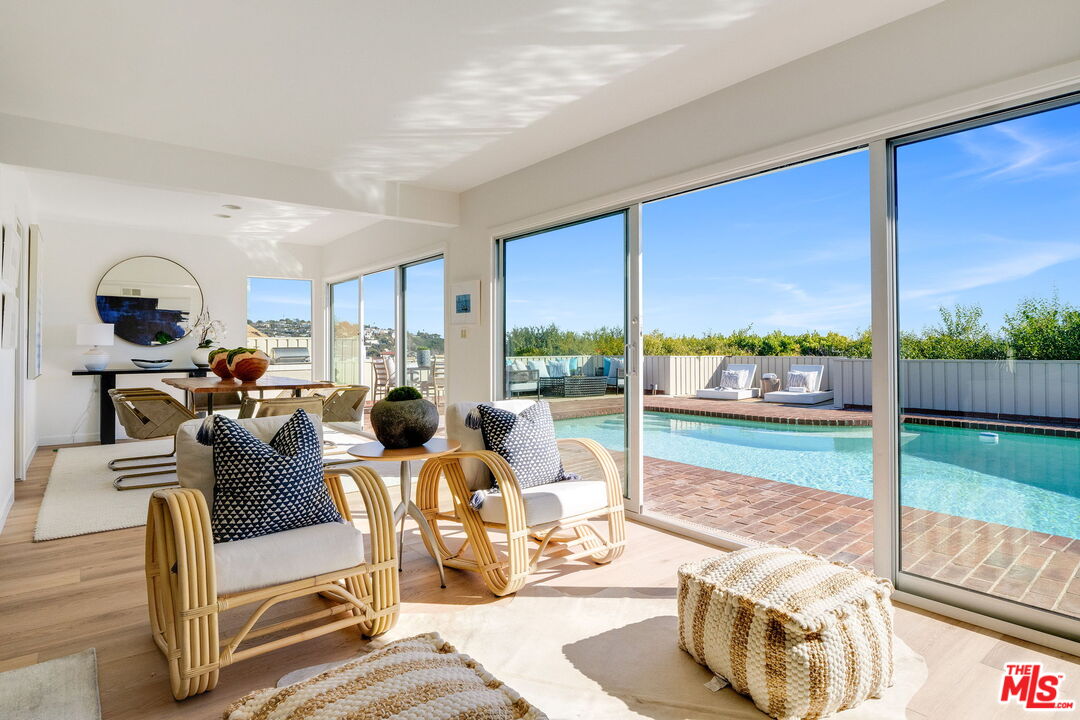 18332 Wakecrest Drive Malibu, CA 90265 - Photo 11 of 30 a living room with furniture floor to ceiling window and floor to ceiling window