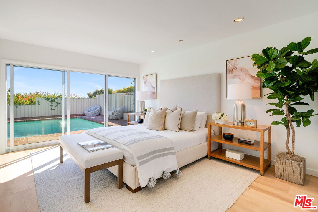 18332 Wakecrest Drive Malibu, CA 90265 - Photo 17 of 30 a living room with a bed furniture and a potted plant