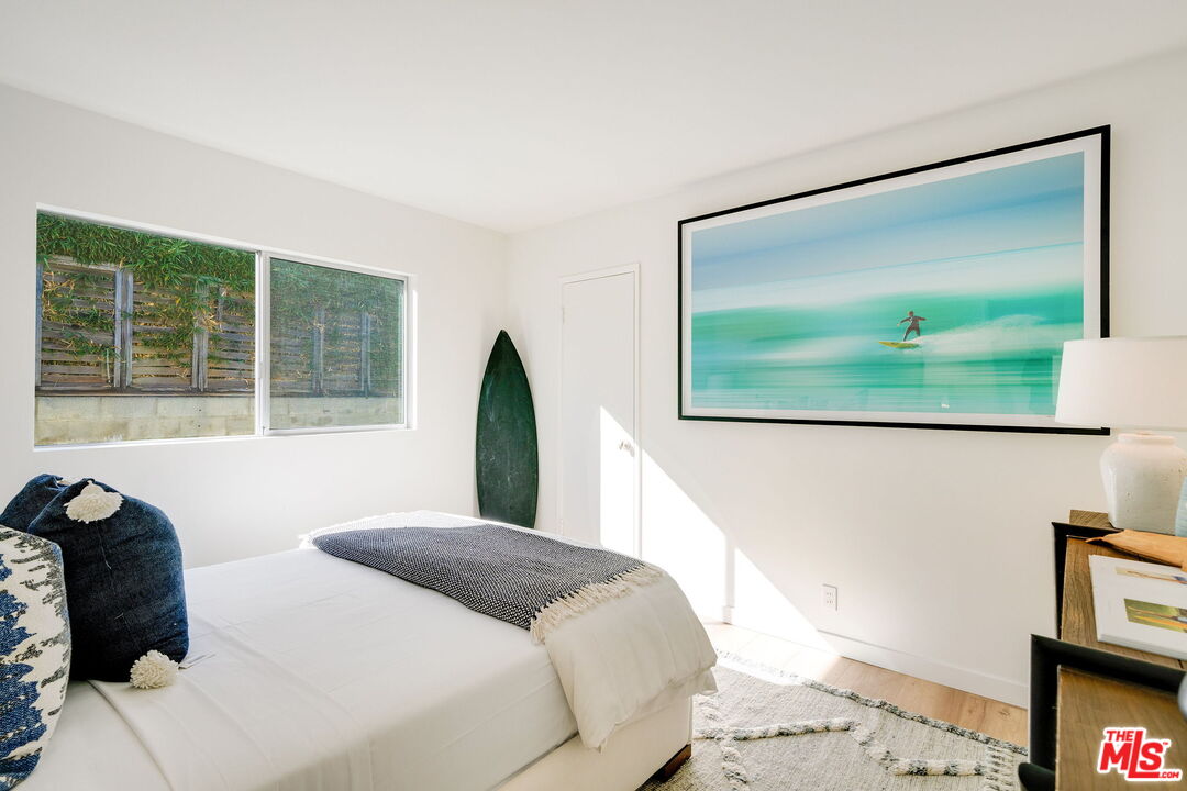 18332 Wakecrest Drive Malibu, CA 90265 - Photo 21 of 30 a bedroom with a bed and a flat screen tv