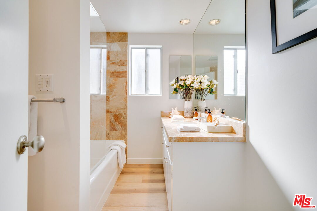 18332 Wakecrest Drive Malibu, CA 90265 - Photo 25 of 30 a bathroom with a tub sink and mirror
