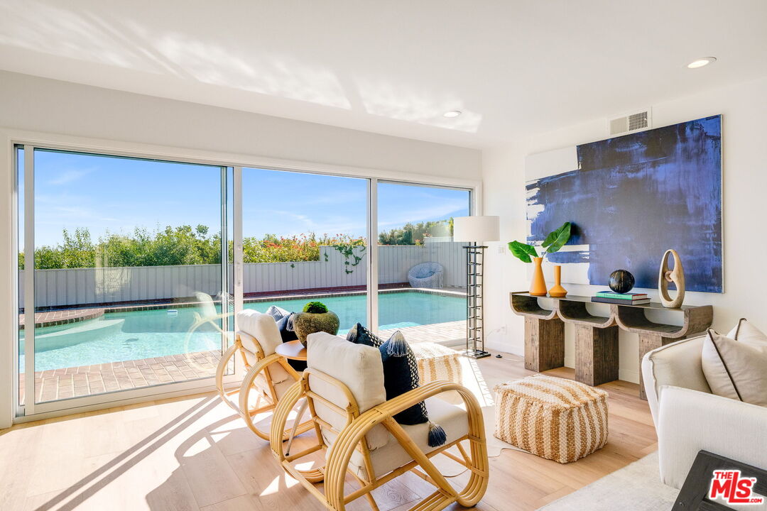 18332 Wakecrest Drive Malibu, CA 90265 - Photo 6 of 30 a living room with furniture and a floor to ceiling window