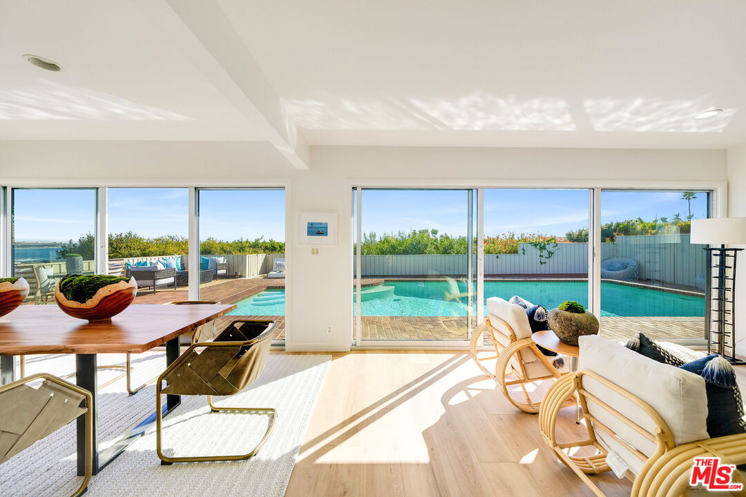 18332 Wakecrest Drive Malibu, CA 90265 - Photo 8 of 30 a living room with patio furniture and a floor to ceiling window