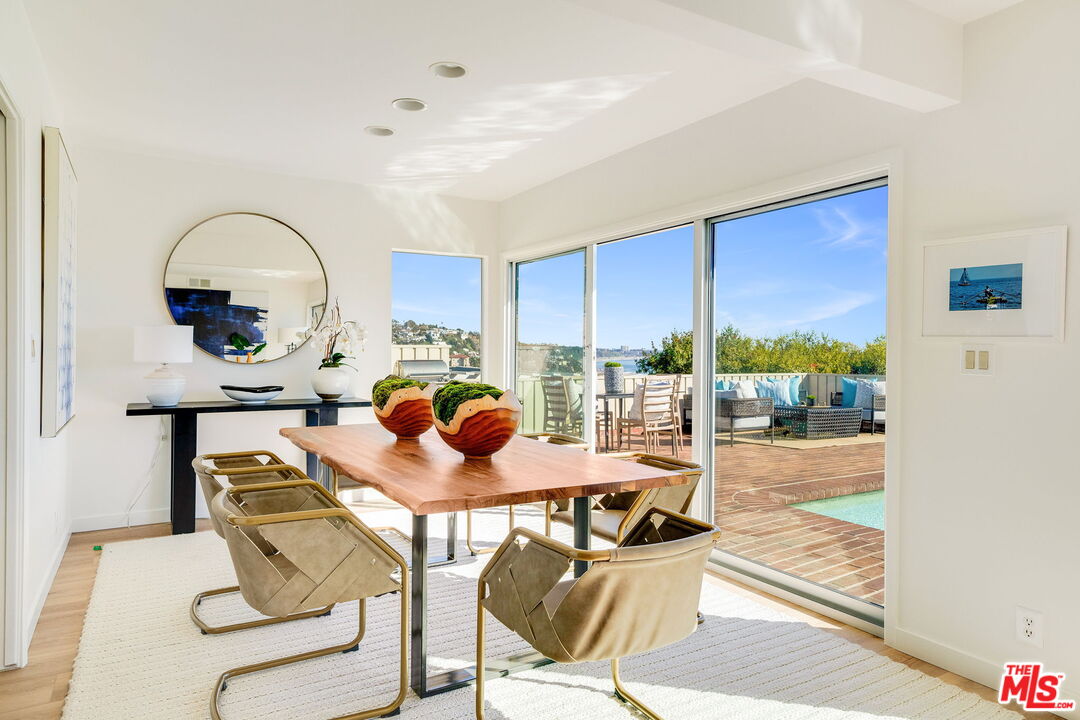 18332 Wakecrest Drive Malibu, CA 90265 - Photo 9 of 30 a view of a dining room with furniture a chandelier and wooden floor