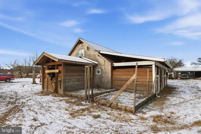 a front view of a house with a yard covered in snow