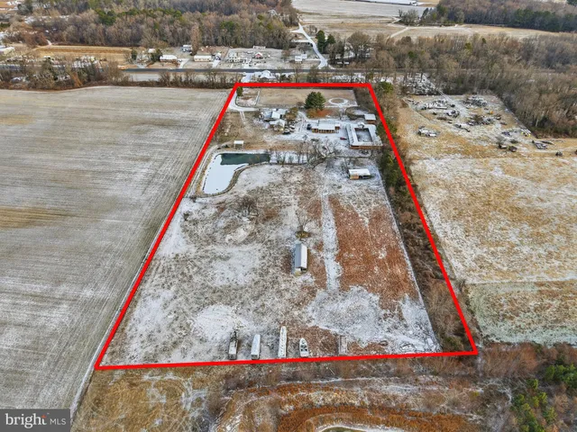 an aerial view of a house with garden space and parking