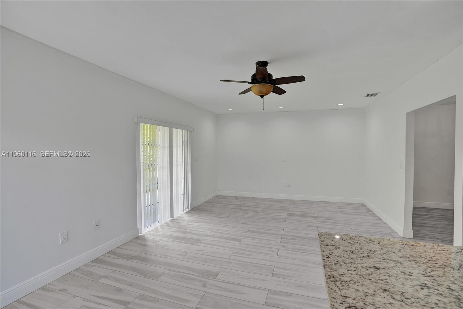 5721 Southwest 11th Street West Miami, FL 33144 - Photo 14 of 44 a view of empty room with wooden floor and ceiling fan