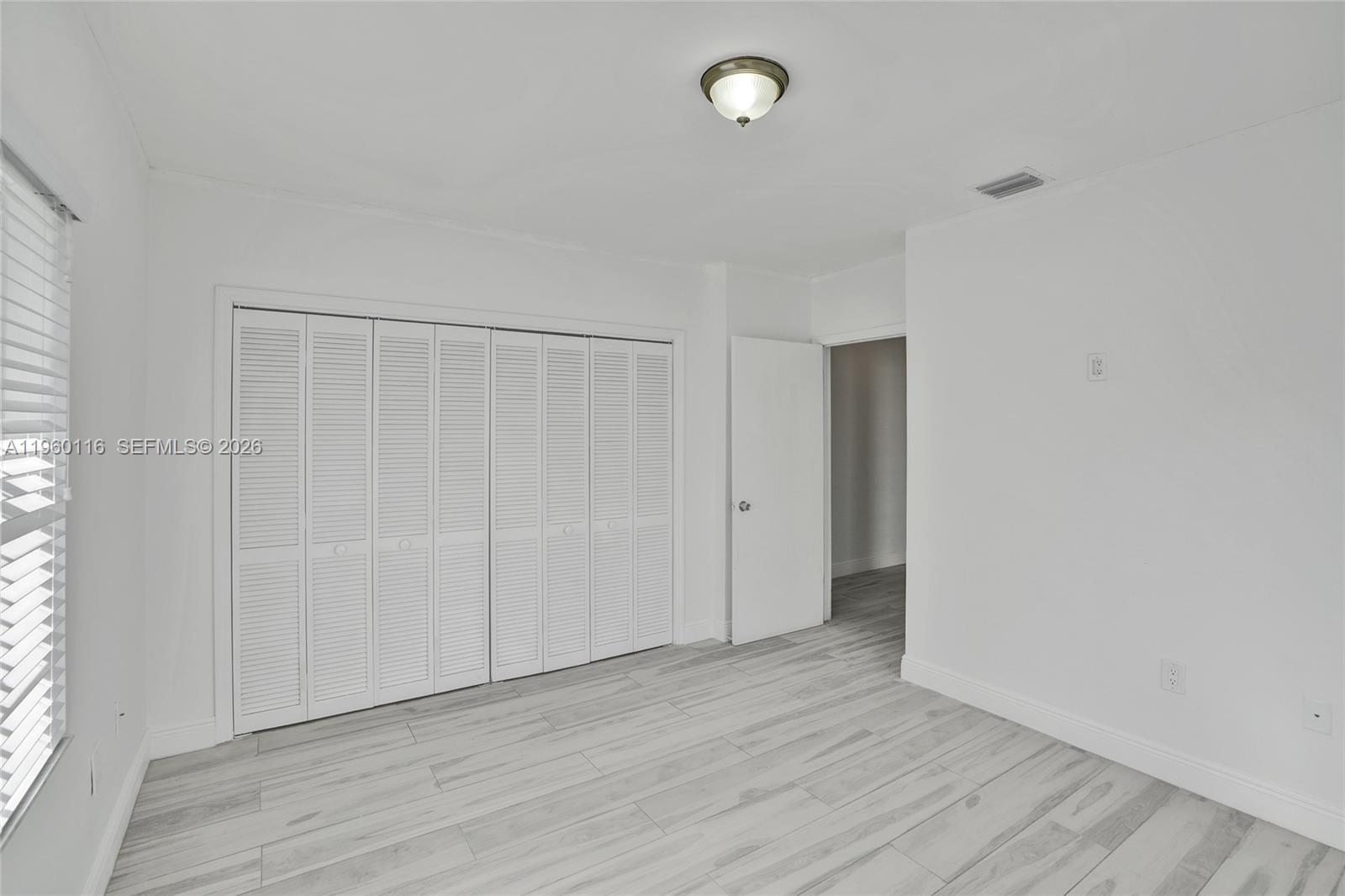 5721 Southwest 11th Street West Miami, FL 33144 - Photo 17 of 44 a view of an empty room with wooden floor