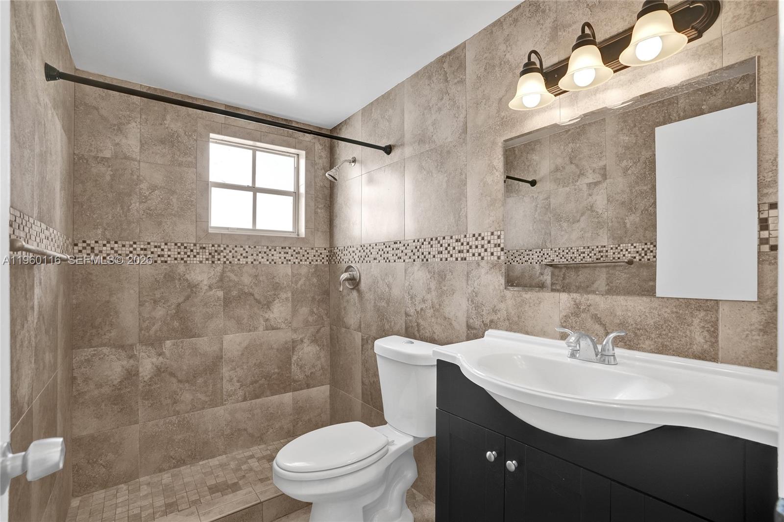 5721 Southwest 11th Street West Miami, FL 33144 - Photo 19 of 44 a bathroom with a sink a toilet and shower