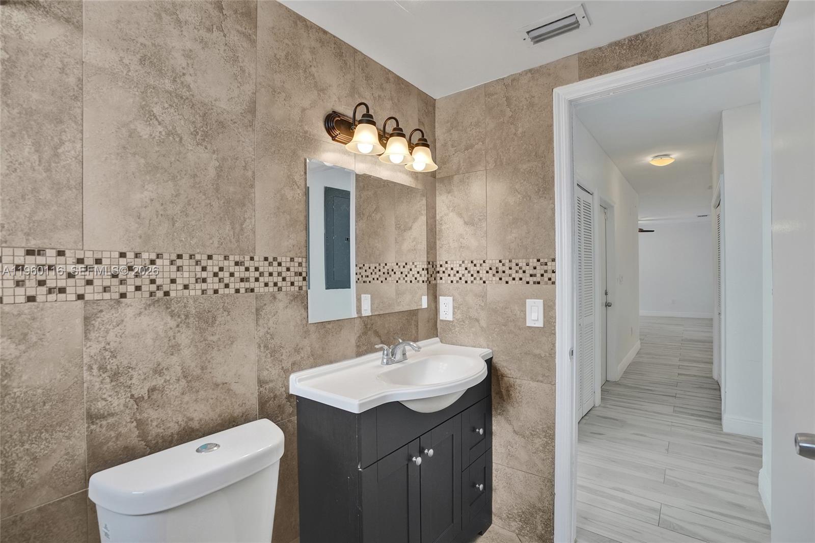 5721 Southwest 11th Street West Miami, FL 33144 - Photo 20 of 44 a bathroom with a sink a toilet and shower