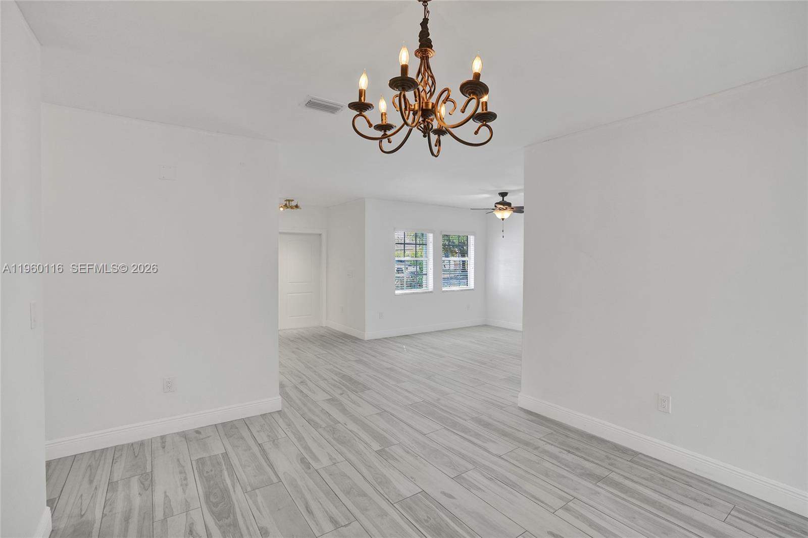 5721 Southwest 11th Street West Miami, FL 33144 - Photo 2 of 44 a view of a room with wooden floor and a window