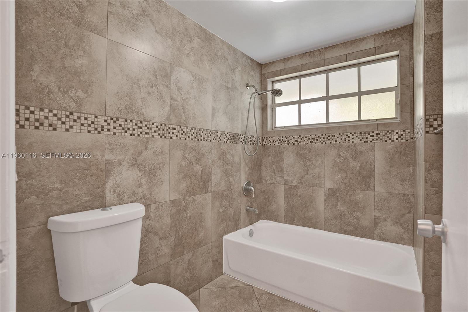 5721 Southwest 11th Street West Miami, FL 33144 - Photo 27 of 44 a bathroom with a toilet a sink and bathtub