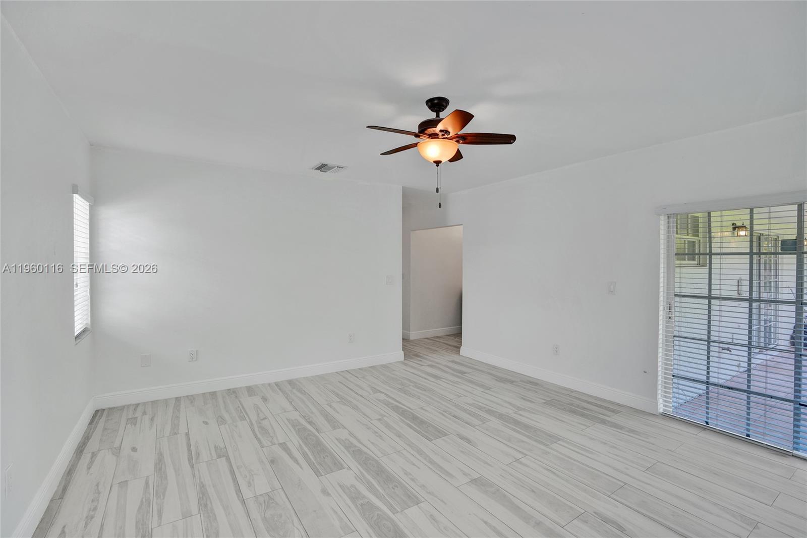 5721 Southwest 11th Street West Miami, FL 33144 - Photo 30 of 44 wooden floor in an empty room with a window