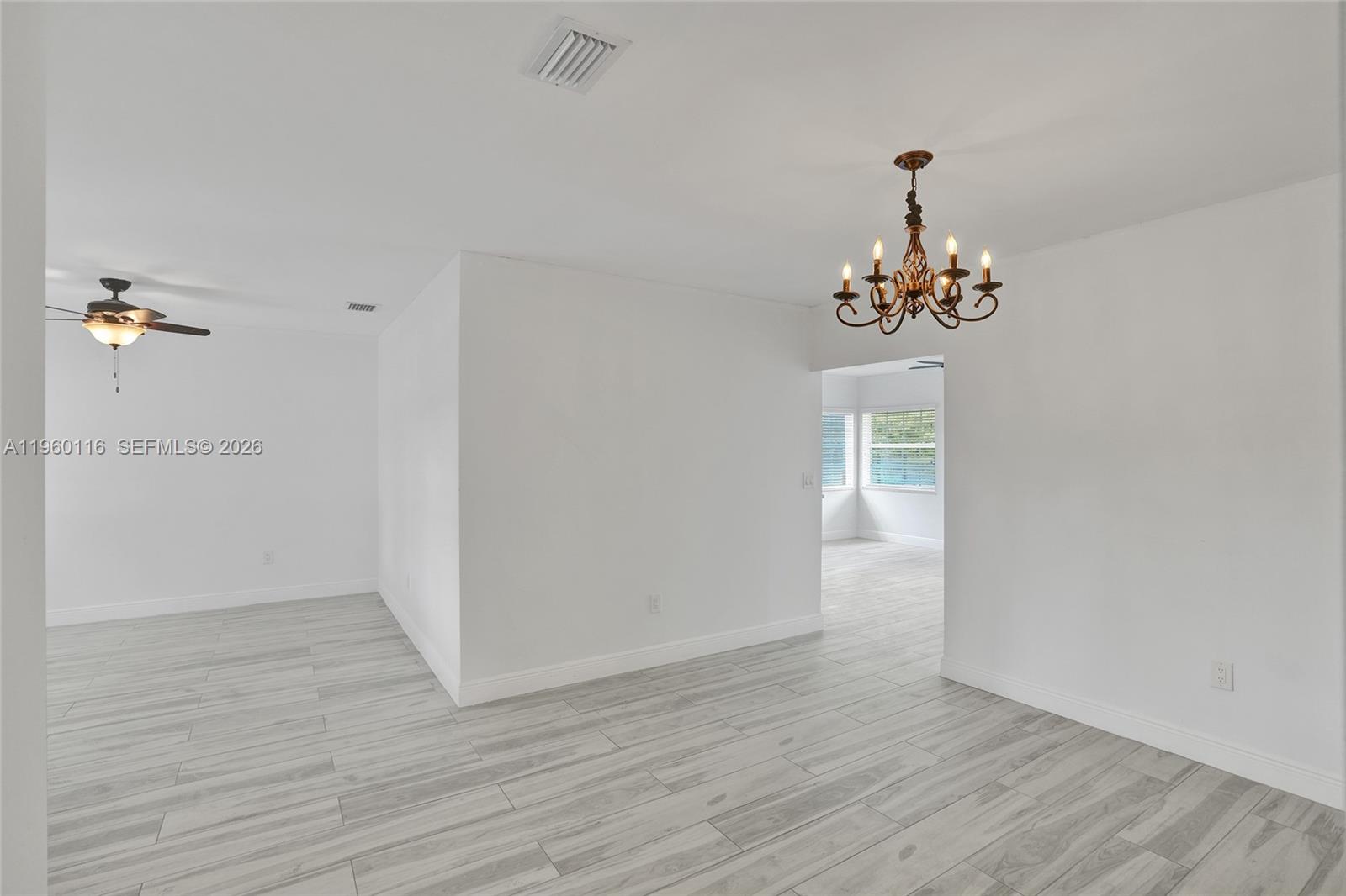 5721 Southwest 11th Street West Miami, FL 33144 - Photo 3 of 44 an empty room with wooden floor