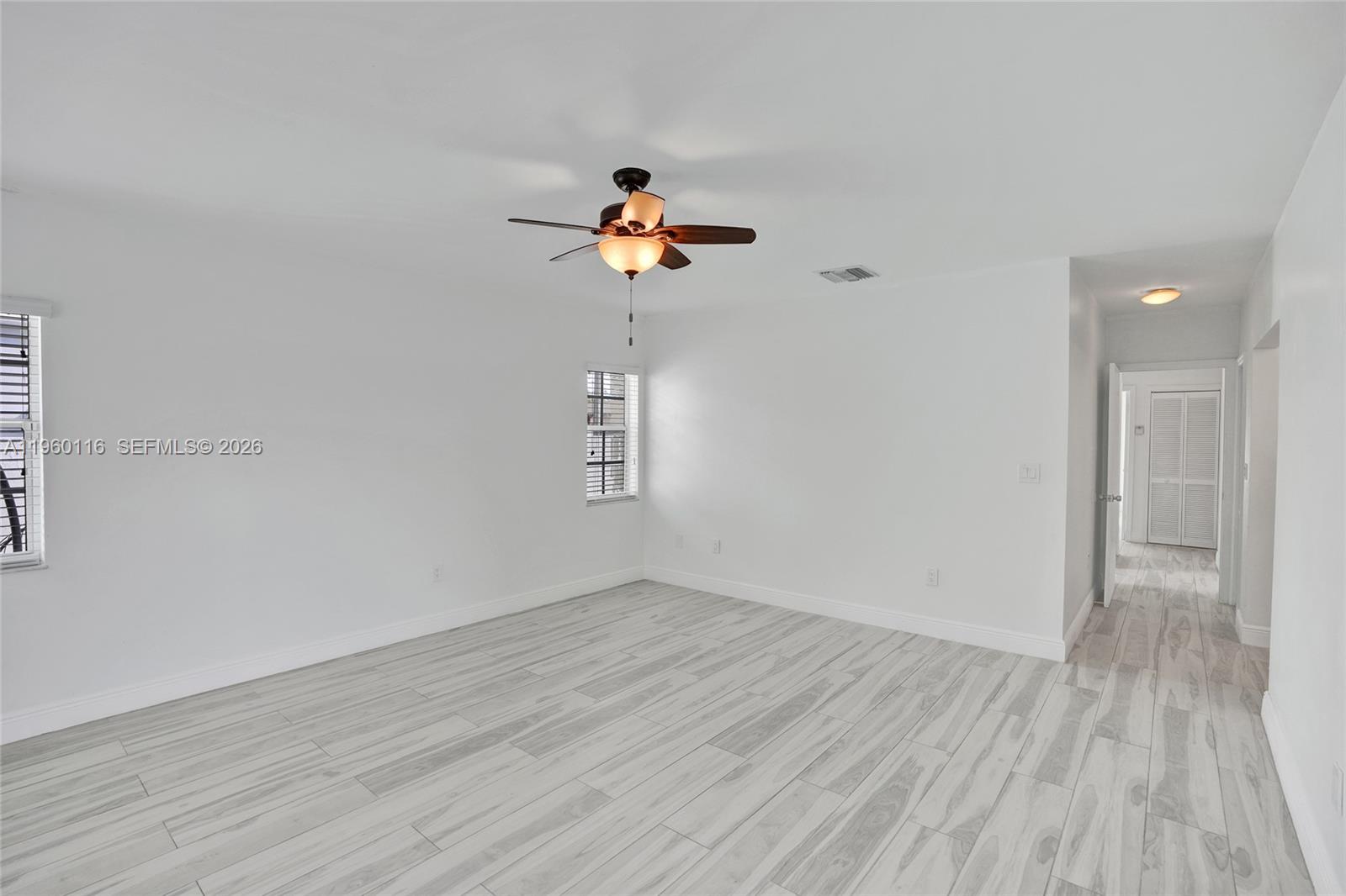 5721 Southwest 11th Street West Miami, FL 33144 - Photo 31 of 44 wooden floor in an empty room with a window