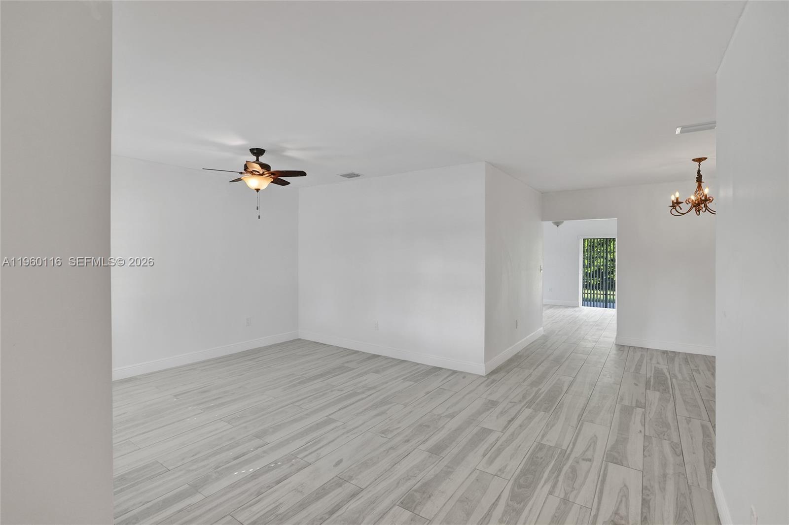 5721 Southwest 11th Street West Miami, FL 33144 - Photo 34 of 44 wooden floor in an empty room with a window
