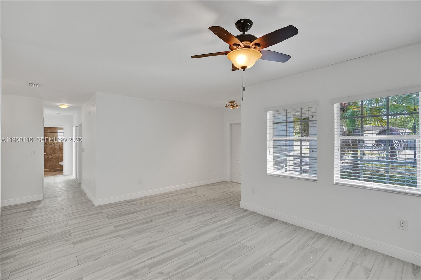 5721 Southwest 11th Street West Miami, FL 33144 - Photo 36 of 44 a view of an empty room with wooden floor and a window