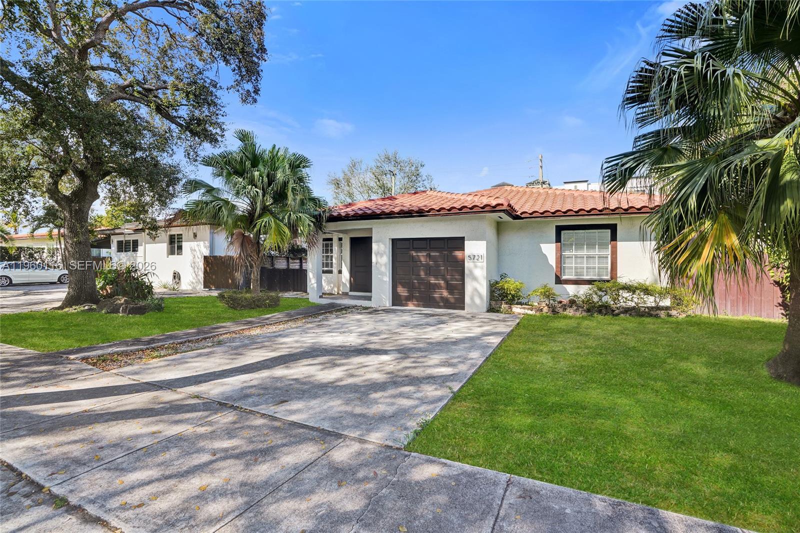 5721 Southwest 11th Street West Miami, FL 33144 - Photo 43 of 44 a front view of a house with a garden and yard