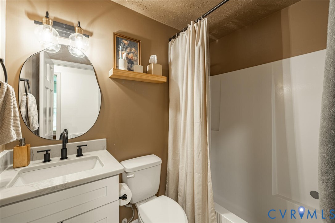 12397 New Market Mill Road Beaverdam, VA 23015 - Photo 22 of 44 a bathroom with a toilet sink and mirror