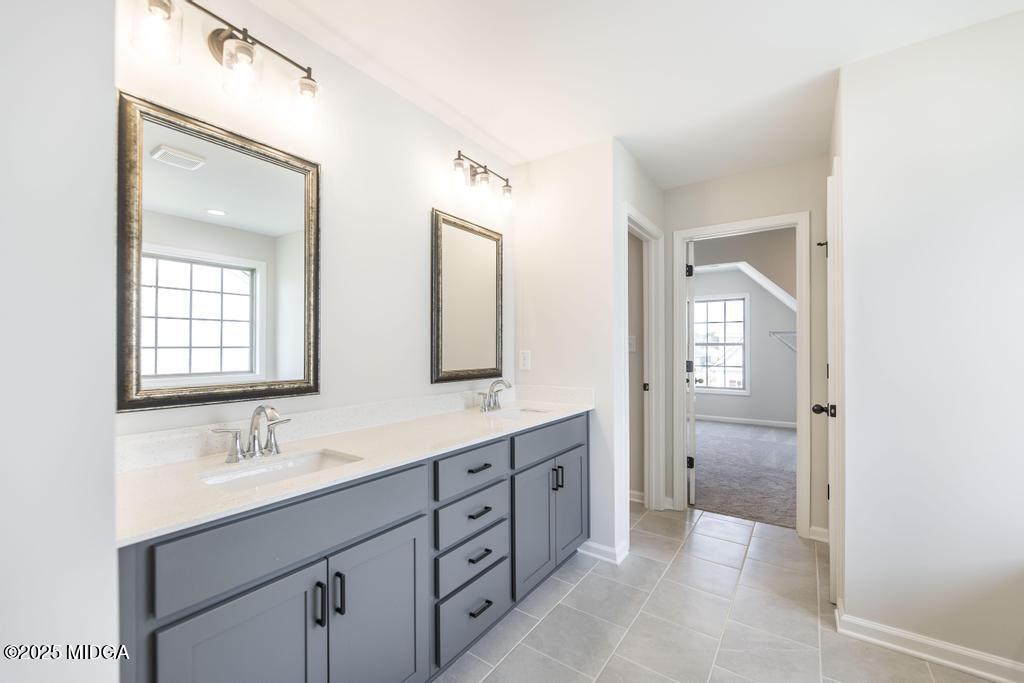 102 Black Birch Road, Unit 83G Perry, GA 31069 - Photo 27 of 31 a bathroom with double sink and a mirror