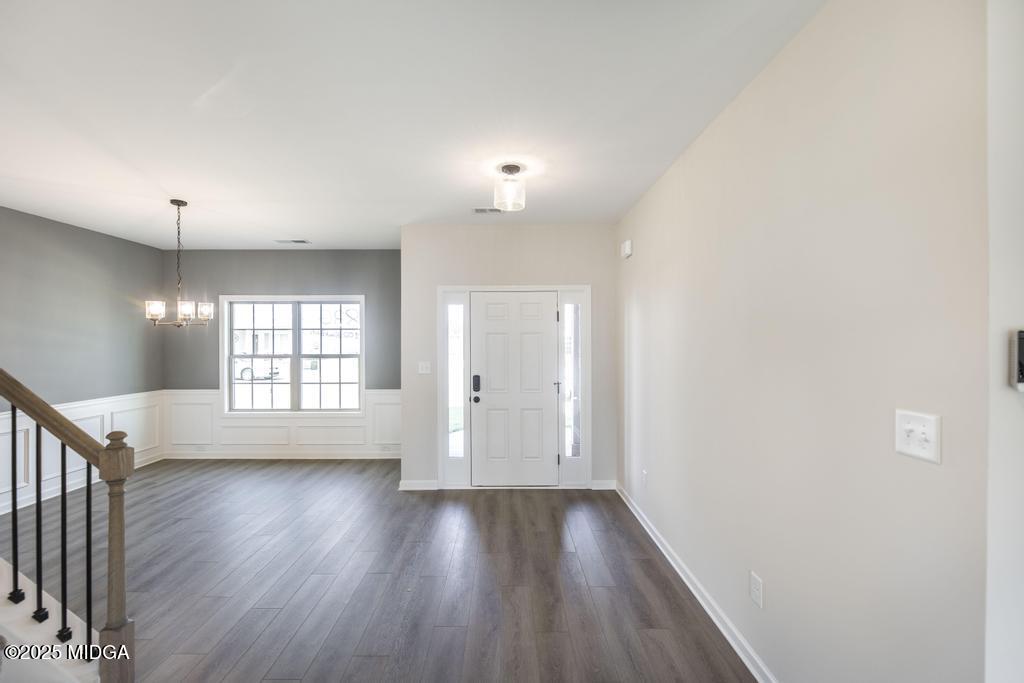 102 Black Birch Road, Unit 83G Perry, GA 31069 - Photo 4 of 31 an empty room with wooden floor and windows