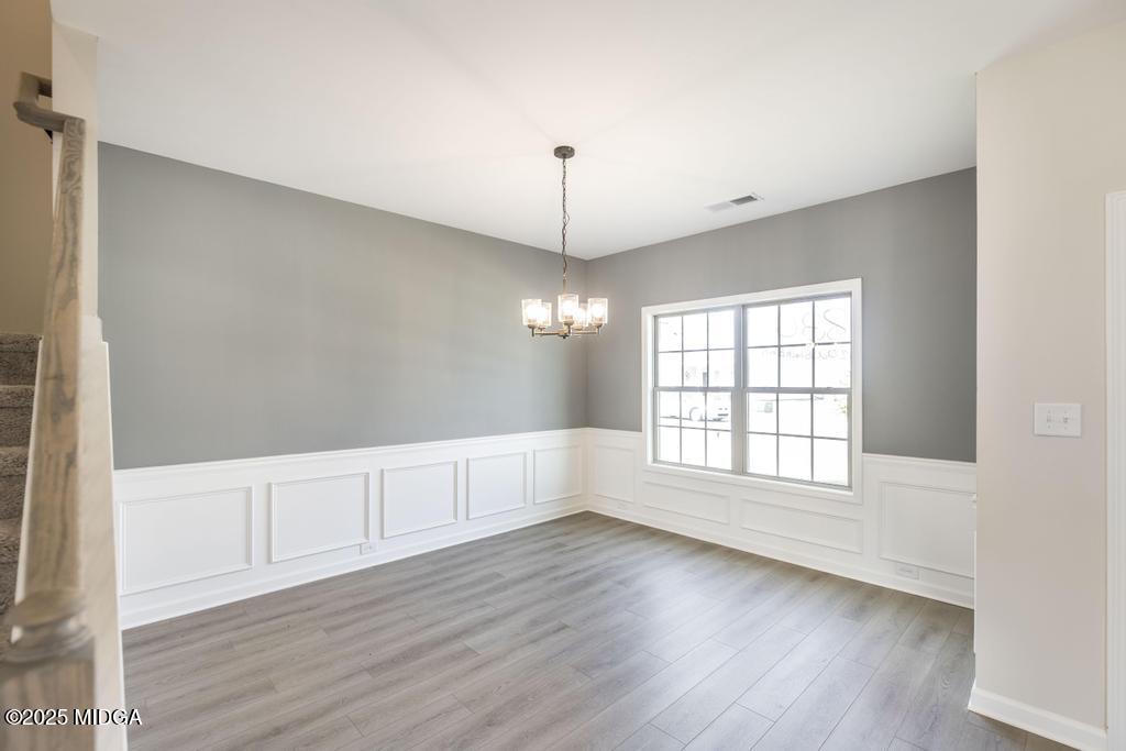 102 Black Birch Road, Unit 83G Perry, GA 31069 - Photo 5 of 31 wooden floor in an empty room with a window