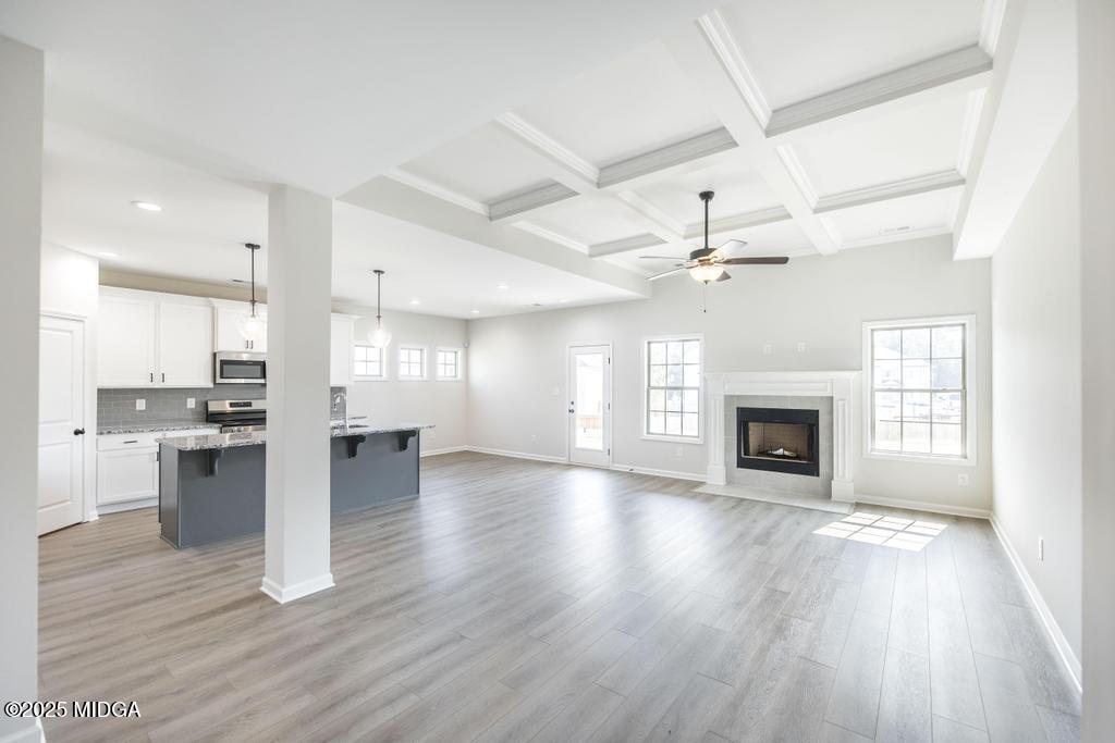 102 Black Birch Road, Unit 83G Perry, GA 31069 - Photo 6 of 31 a view of an empty room with a kitchen and fireplace