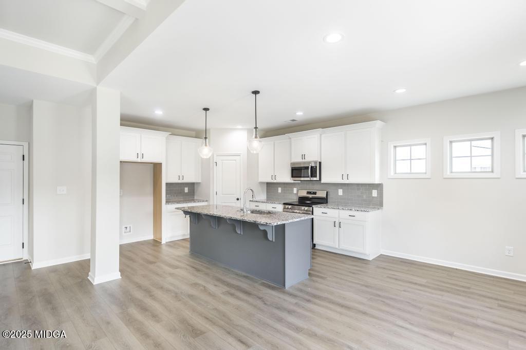 102 Black Birch Road, Unit 83G Perry, GA 31069 - Photo 8 of 31 a kitchen with cabinets and wooden floor