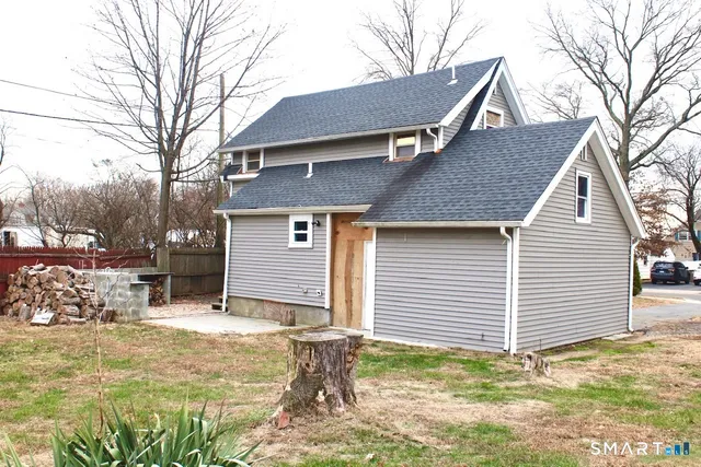 a view of a house with a yard covered in snow