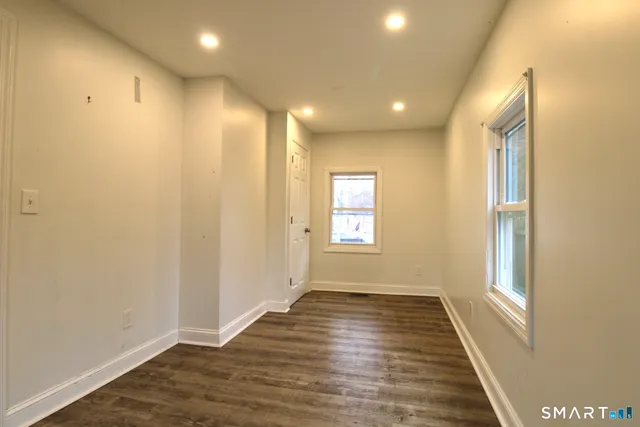a view of hallway with wooden floor